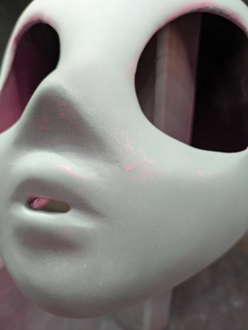 Close-up of sanded mask surface showing sculpt detail